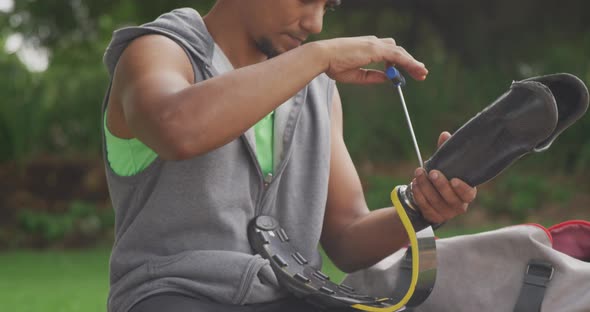 Side view man readjusting his prosthetic leg alt