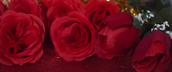 Silk red roses on red glitter