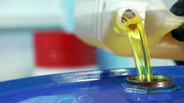 Inside the Room at the Gas Station From the Canister Pour Engine Oil Into the Neck of the Metal alt