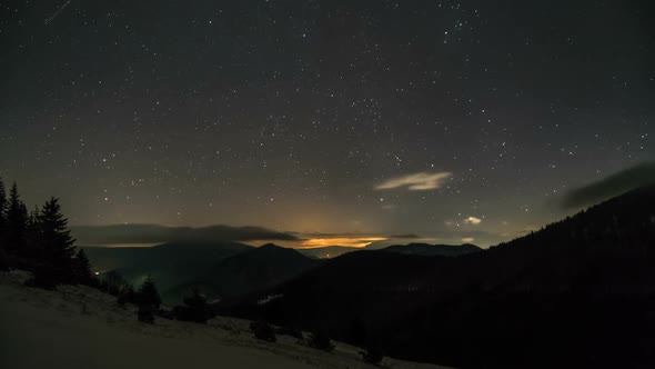 Starry Night Sky with Stars and Low Clouds Moving over Mountains Nature Astronomy alt
