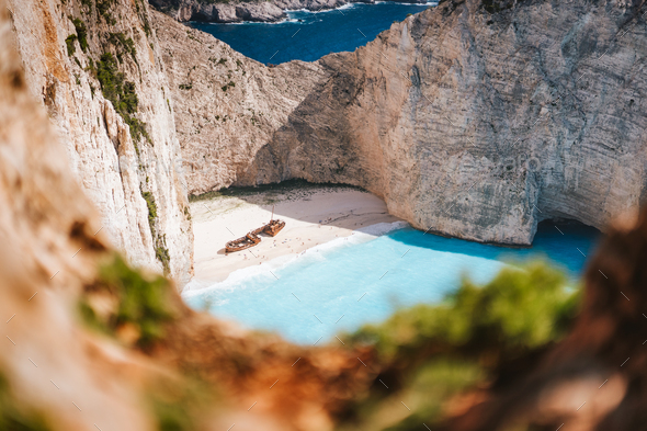 Navagio beach or Shipwreck bay. Turquoise sea water and white beach between huge rocky cliffs - Stock Photo - Images