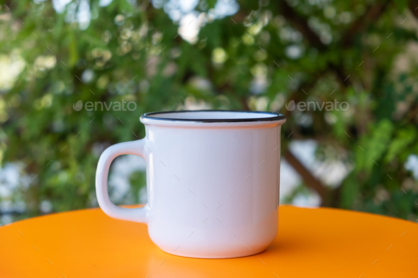 Download Placeit Coffee Cup Mockup On A Yellow Table Blur Green Background Stock Photo By Rawf8