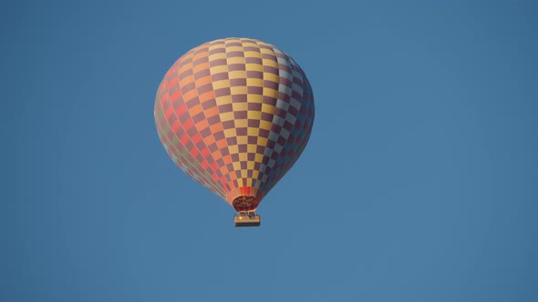 Huge Hot Air Balloon Fly on a Blue Sky Background alt