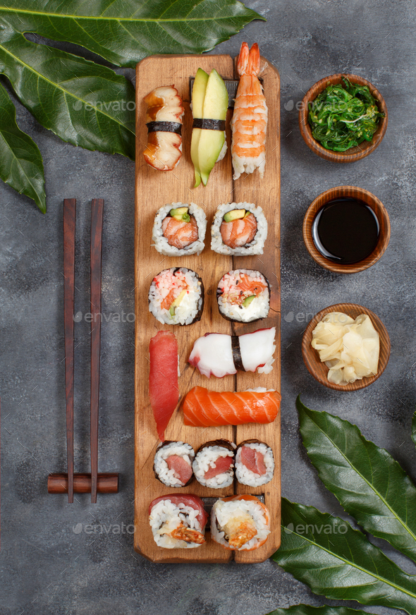 Sushi Set nigiri and sushi rolls on rectangular wooden plates