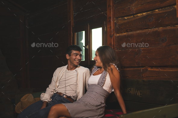Two Friends Flirting and Having a Conversation in an Old Wagon. Ranch Concept Photography