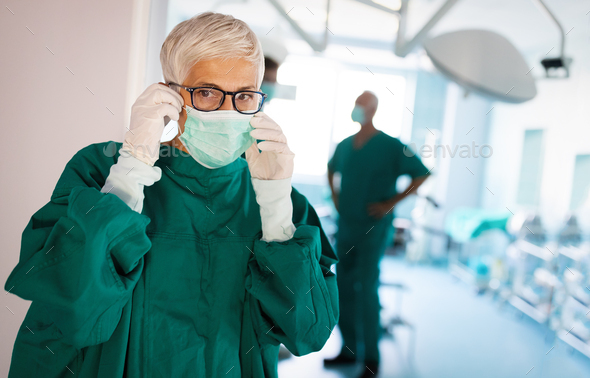 Portrait of senior woman surgeon wearing surgical mask in the operating room