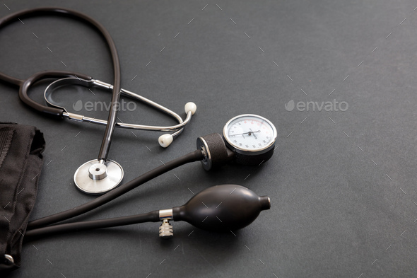 Medical stethoscope and sphygmomanometer on black background Stock Photo by  rawf8