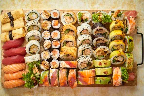 Above view of various sushi and rolls placed on wooden board. Japanese food  fest Stock Photo by Daniel_Dash