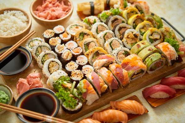 Above view of various sushi and rolls placed on wooden board. Japanese food  fest Stock Photo by Daniel_Dash