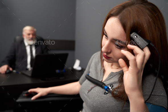 Woman leaning head on hand with finger sensor