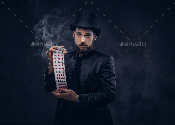 Magician showing trick with playing cards. - Stock Photo - Images