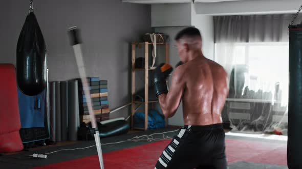 Shirtless Young Man Boxer Training to Dodge in the Gym alt