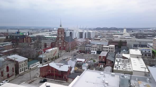 Drone shot of Louisville Kentucky's infrastructure with construction sites, roads and a local church alt