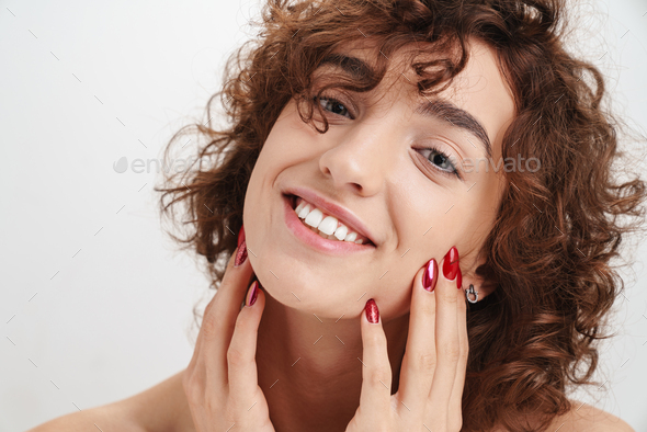 Portrait of a smiling young woman washing dishes Stock Photo by vadymvdrobot