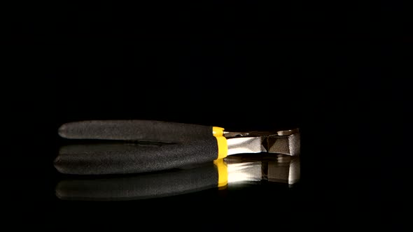 Wire Cutters with Yellow, Gray Handle on Black, Reflection, Rotation alt