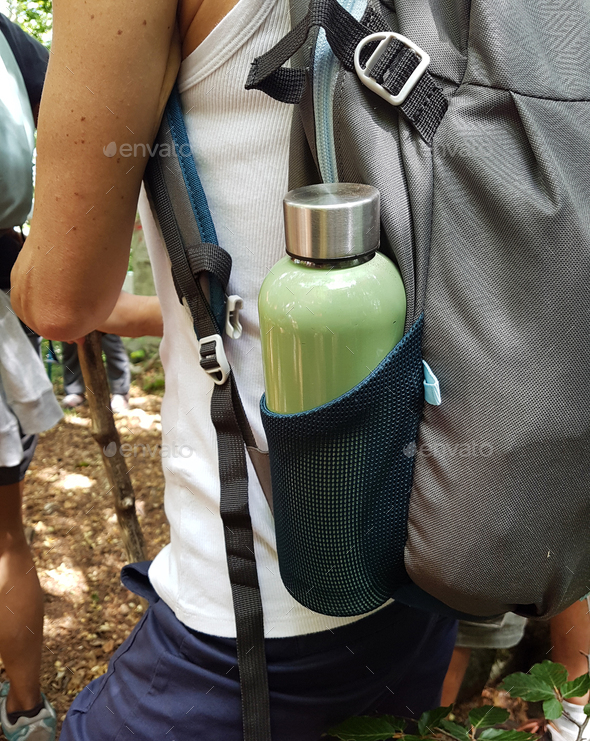 Women stay with Backpack with reusable water bottle in a pocket Stock Photo  by katrinshine