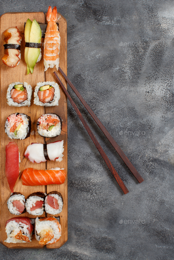 Sushi Set nigiri and sushi rolls on rectangular wooden plates