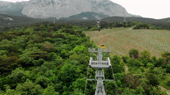 View on the Cable Car with a Rising Funicular Mountains and Green Forest alt