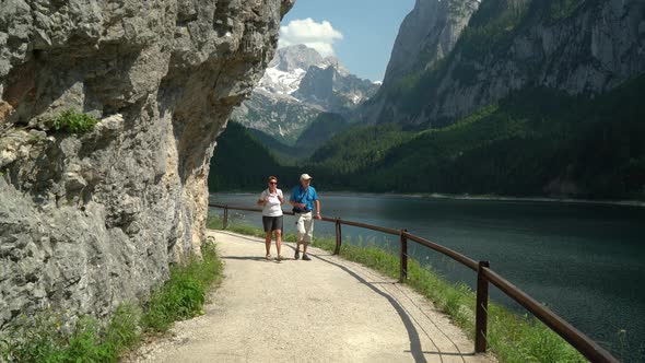 Happy Active Seniors Walking Around Mountain Lake