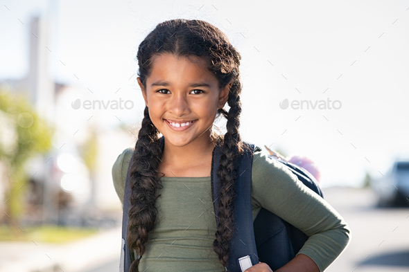 Smiling elementary school girl with bagpack - Stock Photo - Images