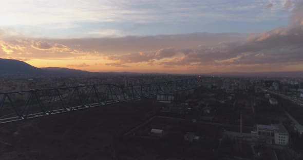 Unfinished Concrete Building with Construction Tower Crane Against Mesmerising Sunset Clouds alt