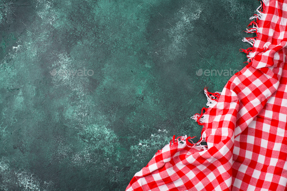 Red checkered tablecloth on green background Stock Photo by furmanphoto