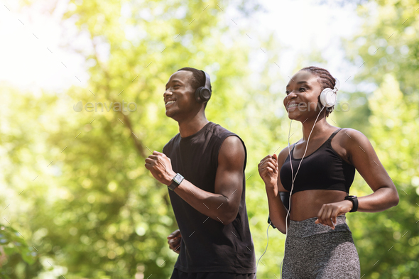 Enjoying Run. Joyful African American Couple Jogging In Summer Park, Copy Space