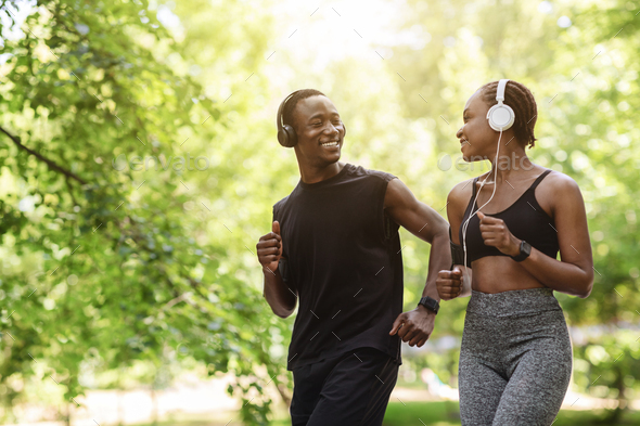 Couples Active Leisure. Happy Black Guy And Girl Jogging Together Outdoors, Enjoying Sporty Lifestyle, Free Space