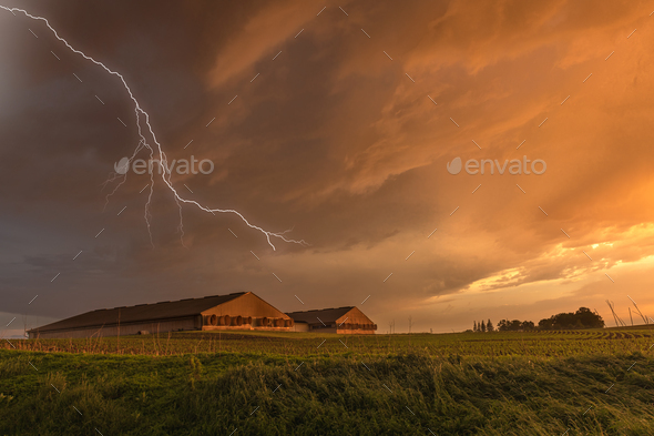 Lightning over grain storage facilities - Stock Photo - Images
