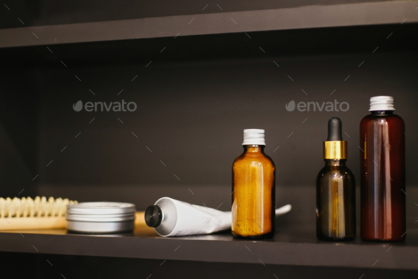 Ubtan for skin in glass bottle, cream in metal can, tonic, conditioner on white sink