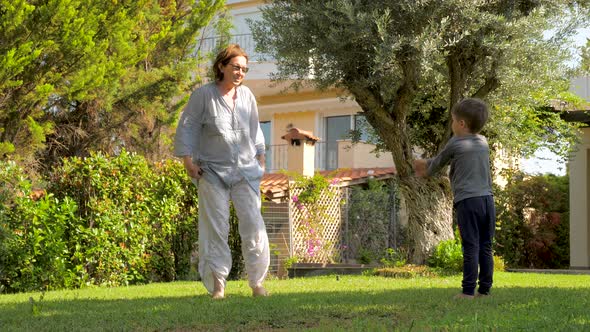 Grandmother with Grandson Doing Sports on Backyard, Front Yard