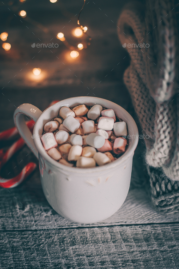 Stack of cozy knitted sweaters and cup of coffee or hot chocolate with marshmallow. Magic, cozy - Stock Photo - Images