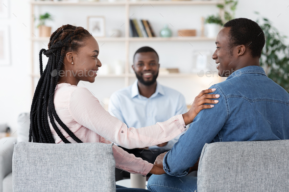 Happy Loving Black Spouses Bonding At Marriage Counselor’s Office After Successful Therapy, Selective Focus