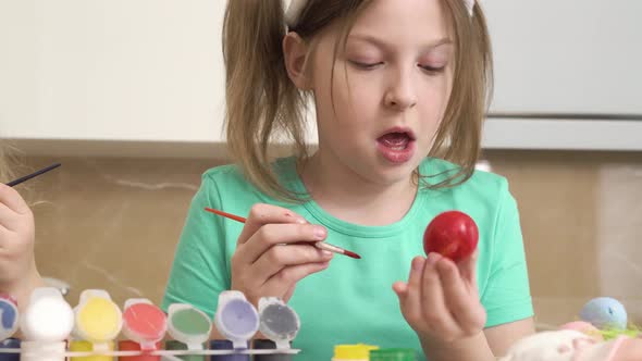 Girls Paint Eggs for the Easter Holiday