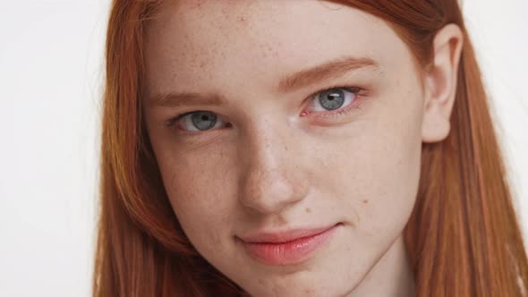 Close Up Footage of Beautiful Caucasian Foxy Teenage Girl Smiling Looking at Camera on White alt