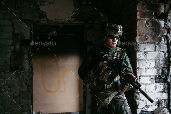 Soldier in combat. Urban combat training, soldier entering abandoned building. Anti terrorist - Stock Photo - Images