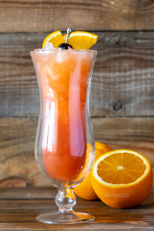 Glass of Hurricane cocktail on wooden background