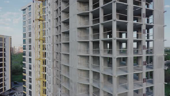 Aerial view of high residential apartment building under construction. Real estate development. alt