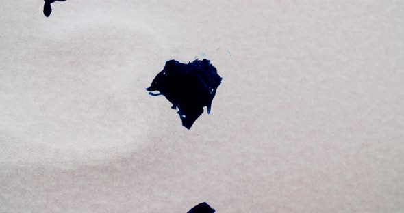 blue three dimensional organic structure floating in a transparent liquid while expanding and growin alt