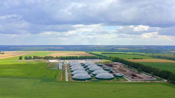 Modern biogas plant in summer. Greenhouse complex for biogas production alt