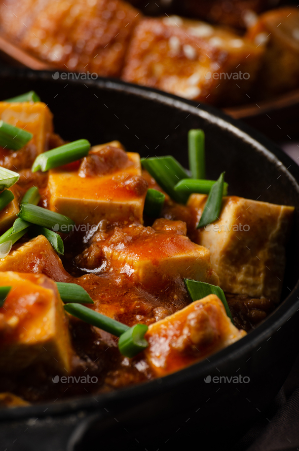 Mapo tofu in cast iron skillet with pork chopped chives soy sauce