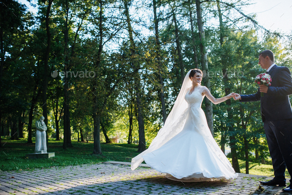 wedding couple dancing in the park - Stock Photo - Images