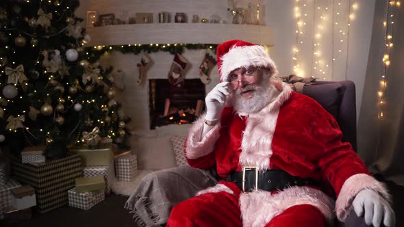 Portrait Authentic Santa Claus Sitting in His Rocker Near Christmas Tree. Christmas Spirit, Holidays