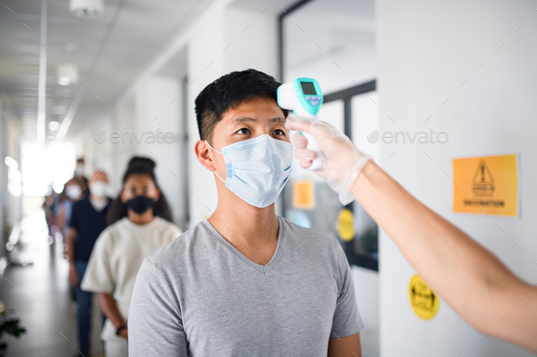 People with face masks, coronavirus, covid-19, measuring temperature and vaccination concept - Stock Photo - Images