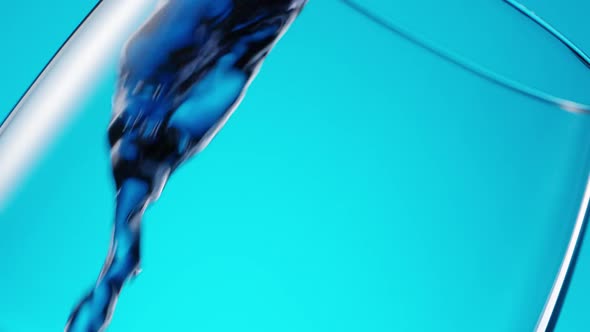Purple Liquid Pouring in Glass at an Angle on Blue alt