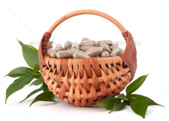 Herbal drug capsules in wicker basket. Alternative medicine concept. - Stock Photo - Images