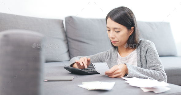 Woman calculate the daily expense at home