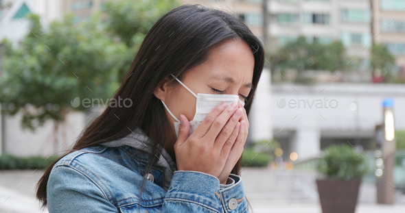 Woman coughing with wearing face mask at outdoor - Stock Photo - Images