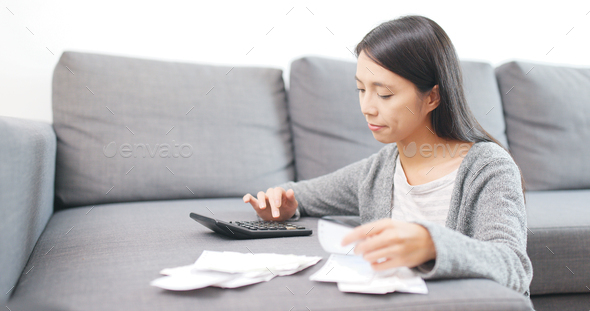 Housewife calculating the expense at home