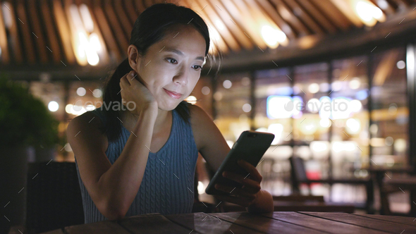 Woman uses smart phone for online - Stock Photo - Images